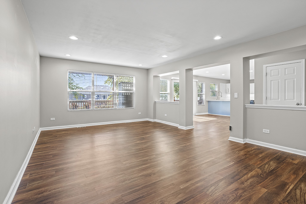6506 Roth Drive Joliet, IL 60431 - Photo 4 of 24 a view of an empty room with wooden floor and a window