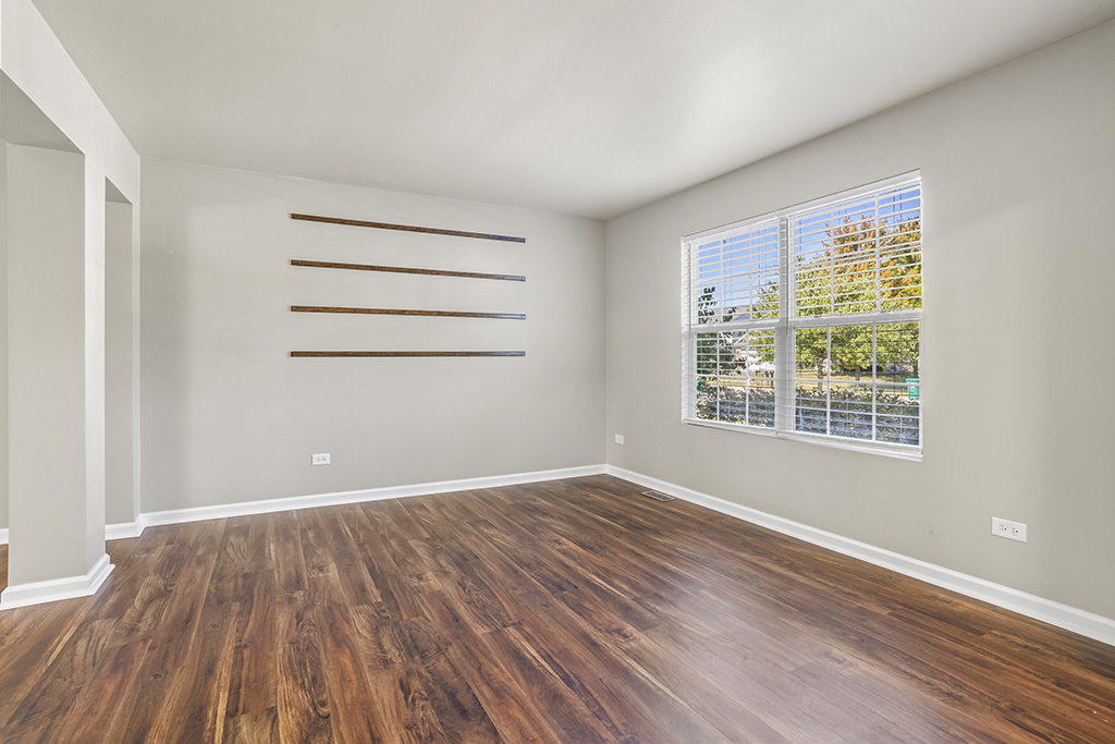 6506 Roth Drive Joliet, IL 60431 - Photo 5 of 24 a view of an empty room with wooden floor and a window