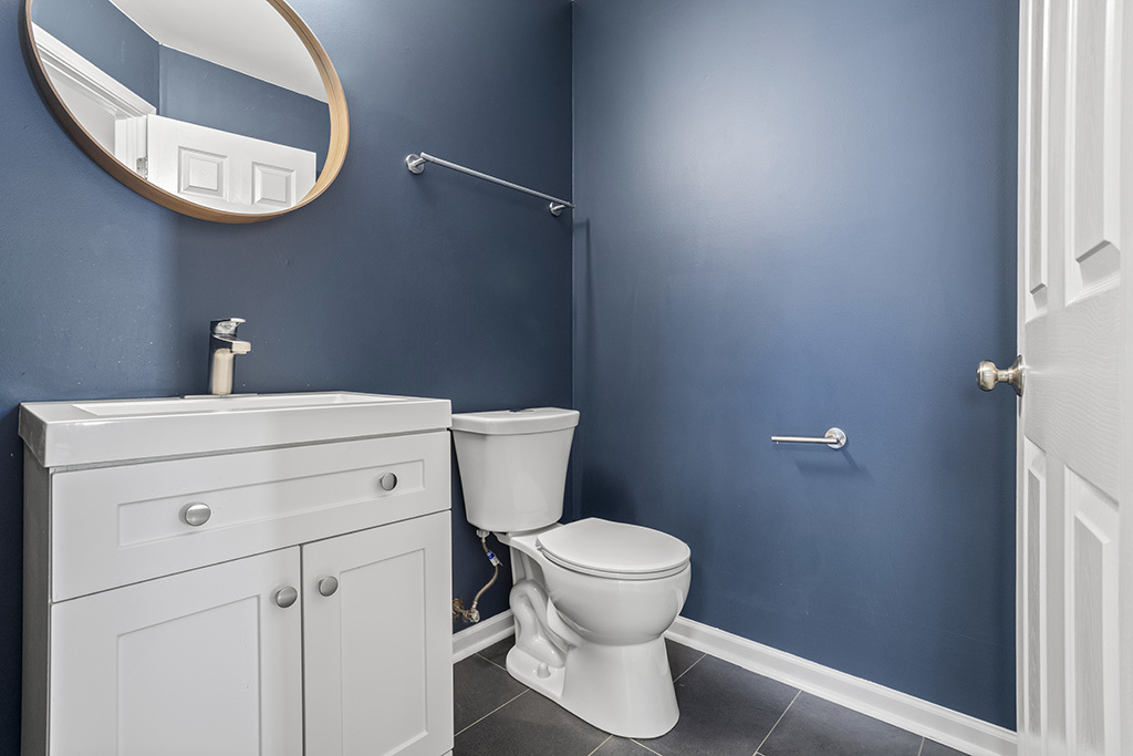 6506 Roth Drive Joliet, IL 60431 - Photo 8 of 24 a bathroom with a toilet and a mirror