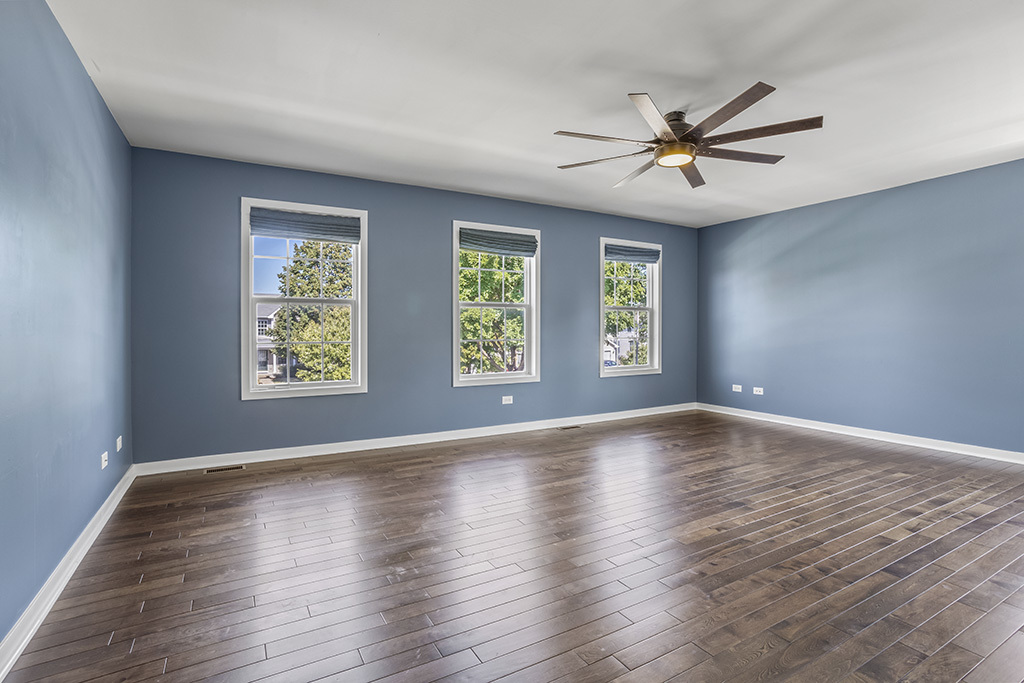 6506 Roth Drive Joliet, IL 60431 - Photo 10 of 24 a view of an empty room with wooden floor and a window