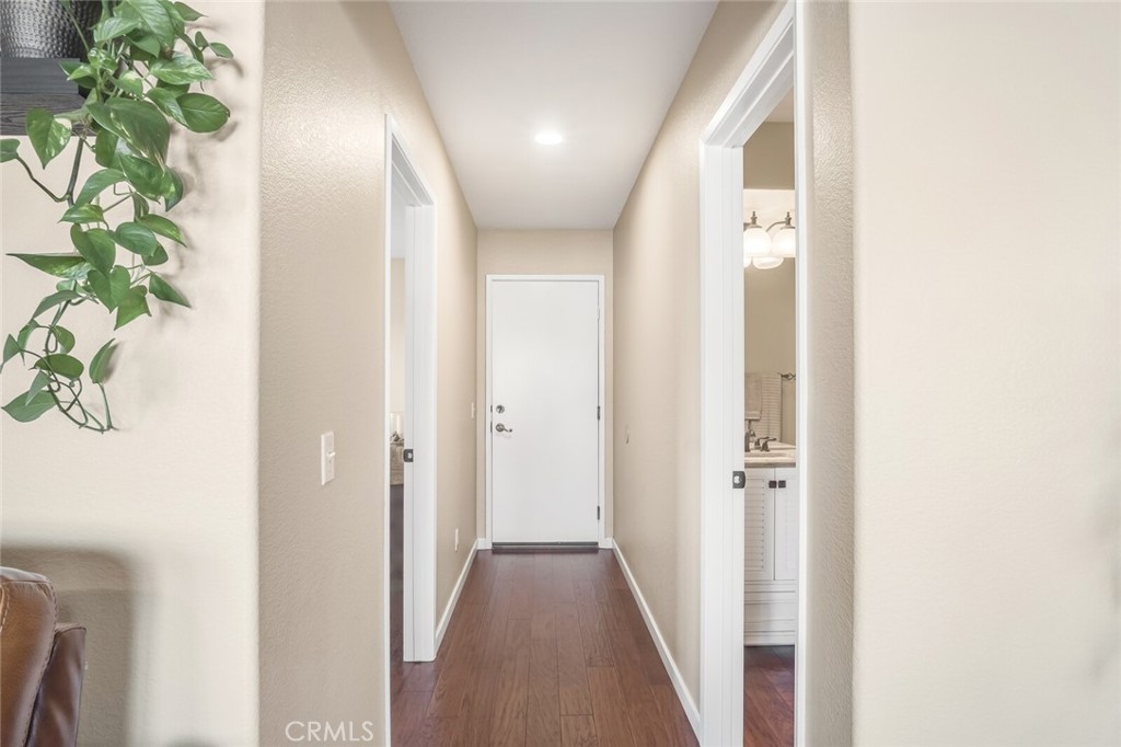 4330 Forest Ranch Way Oceanside, CA 92057 - Photo 16 of 51 Just off the family room, a hallway adds easy function to the main level. A private bedroom sits to the left, with a full bathroom on the right for convenient access. The hallway leads directly to the garage, making daily routines seamless.