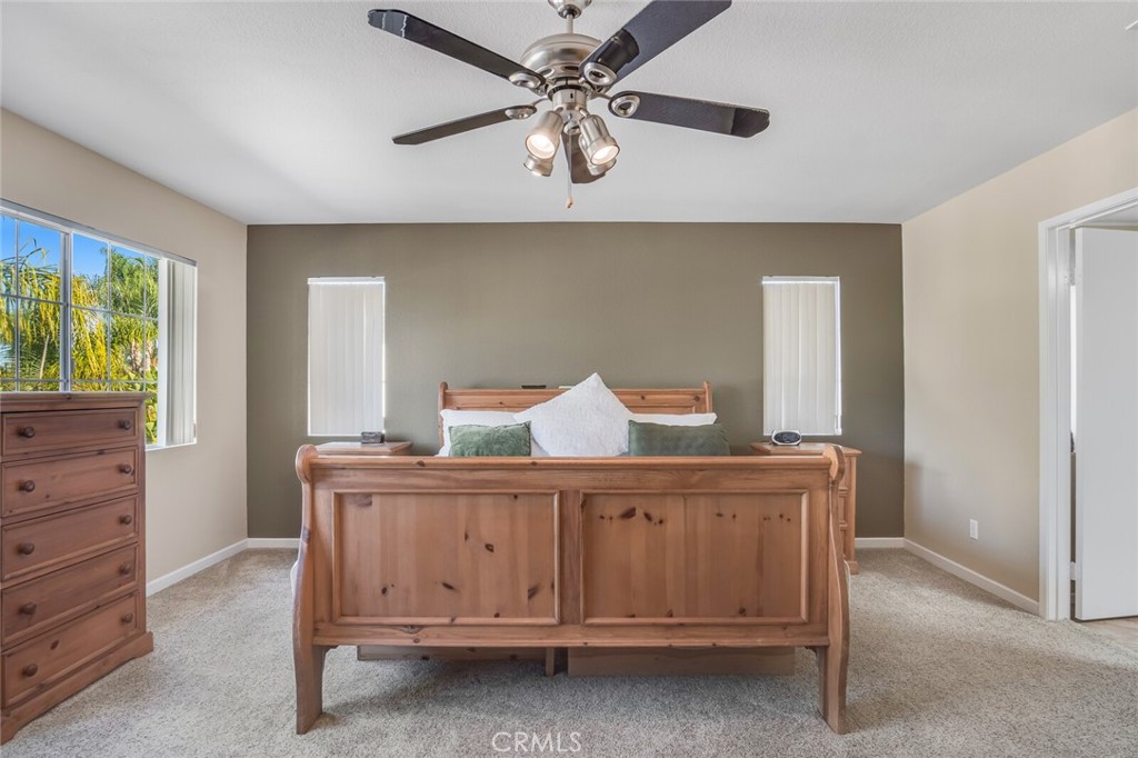 4330 Forest Ranch Way Oceanside, CA 92057 - Photo 21 of 51 The primary suite feels like a place to truly settle in. Large windows bring in natural light, giving the room a soft, relaxed feel throughout the day.
