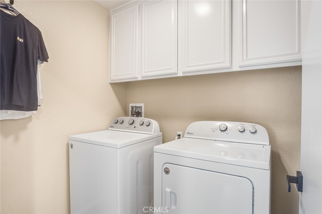 4330 Forest Ranch Way Oceanside, CA 92057 - Photo 33 of 51 Tucked conveniently away on this level, the utility room is designed with practicality in mind. Built-in cabinets provide generous storage for laundry essentials and household items.