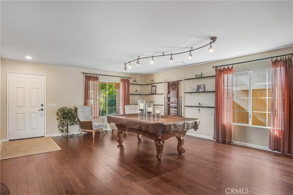 4330 Forest Ranch Way Oceanside, CA 92057 - Photo 8 of 51 The living room is wrapped in an abundance of windows, flooding the space with natural light and creating an airy, inviting atmosphere that instantly feels like home.