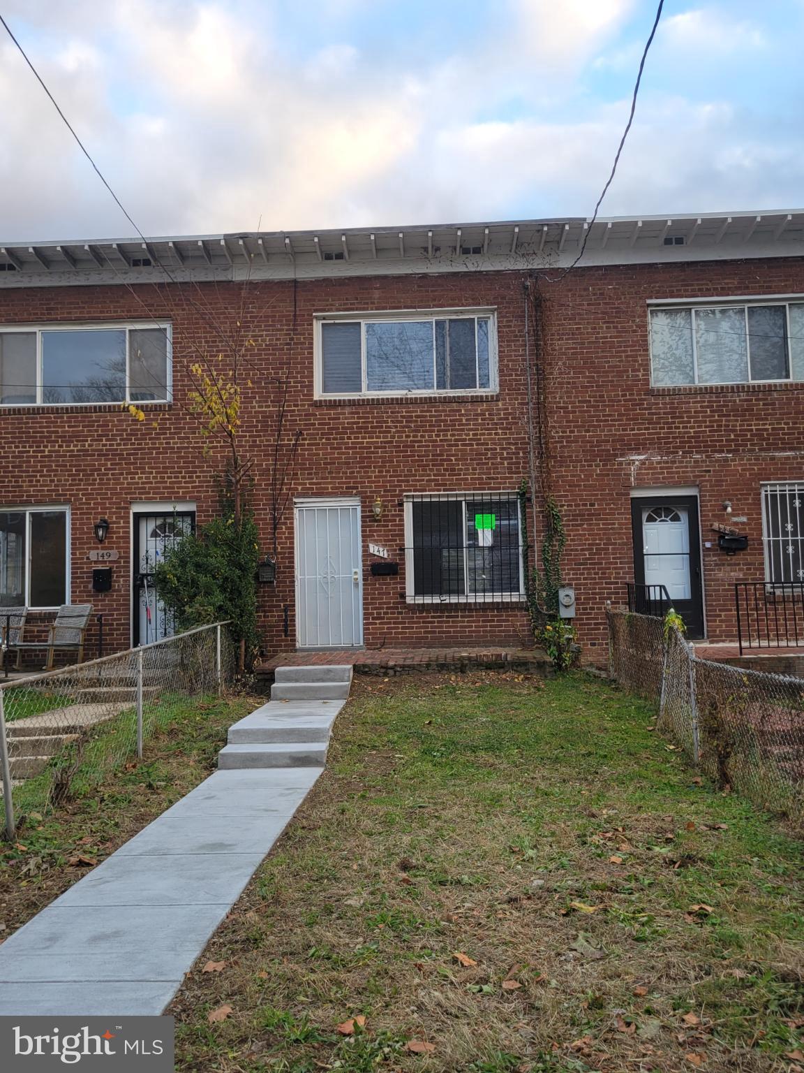 147 Mississippi Avenue Southeast Washington, DC 20032 - Photo 2 of 11 Charming brick townhouse with inviting pathway.