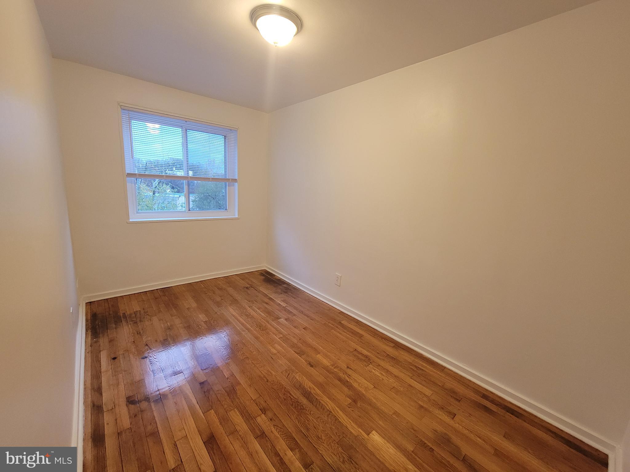 147 Mississippi Avenue Southeast Washington, DC 20032 - Photo 9 of 11 Bright, spacious bedroom with polished floors.