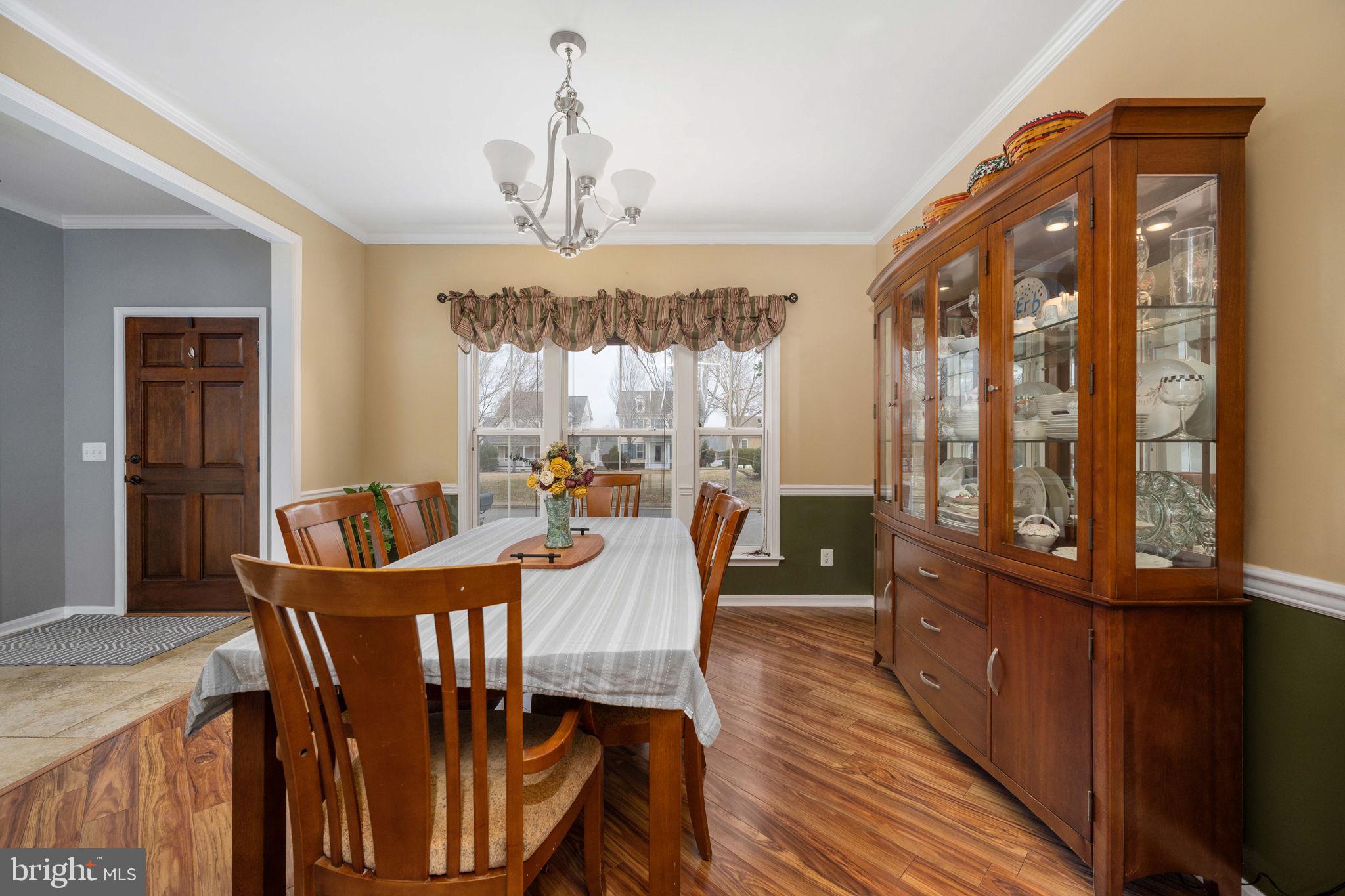 17230 Library Boulevard Ruther Glen, VA 22546 - Photo 11 of 81 a view of a dining room with furniture a chandelier and wooden floor