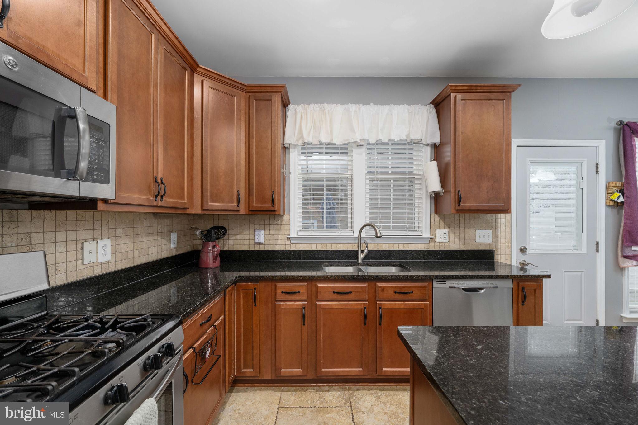 17230 Library Boulevard Ruther Glen, VA 22546 - Photo 21 of 81 a kitchen with stainless steel appliances granite countertop a stove a sink and a microwave