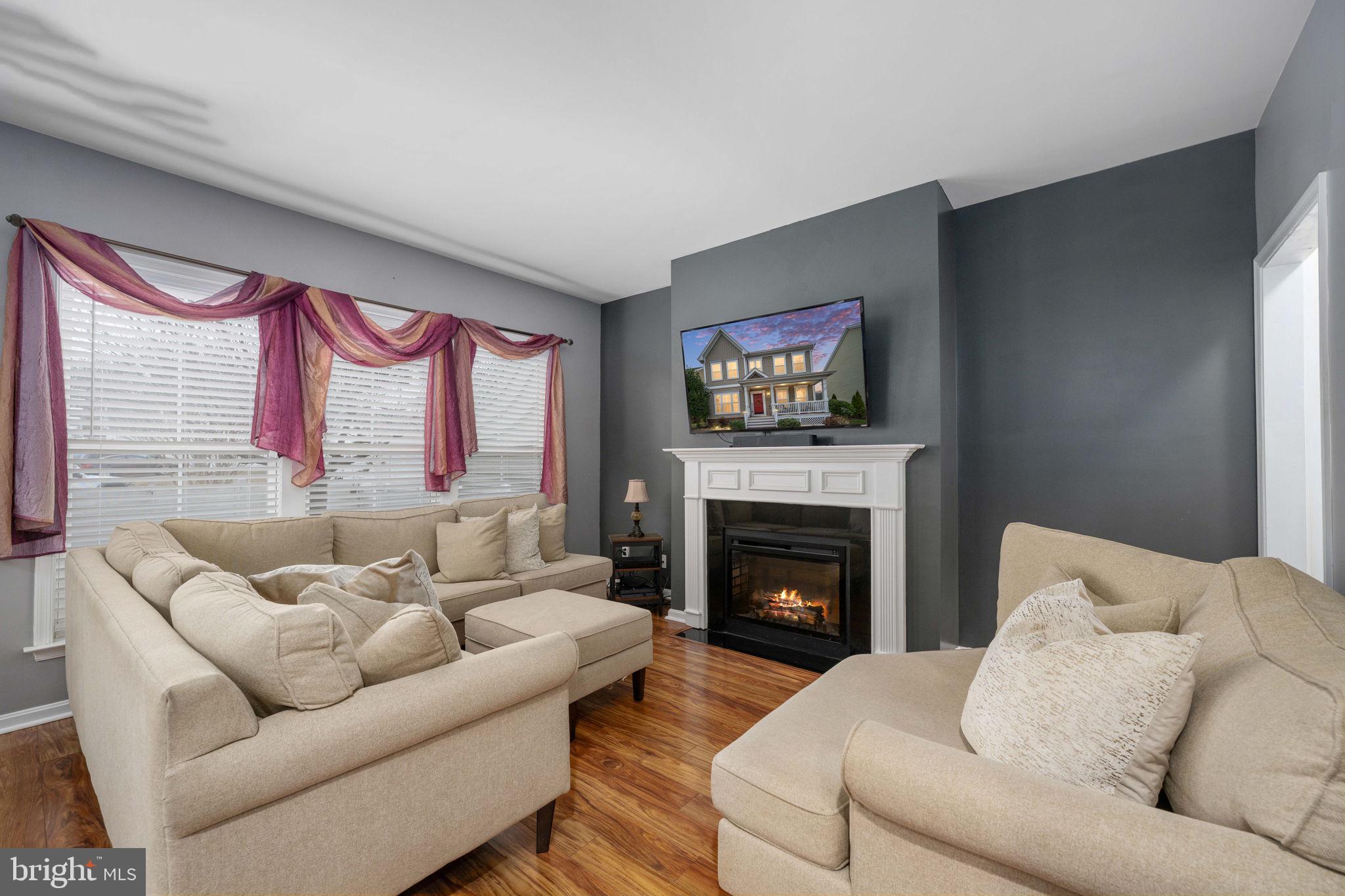17230 Library Boulevard Ruther Glen, VA 22546 - Photo 27 of 81 a living room with furniture window and a fireplace