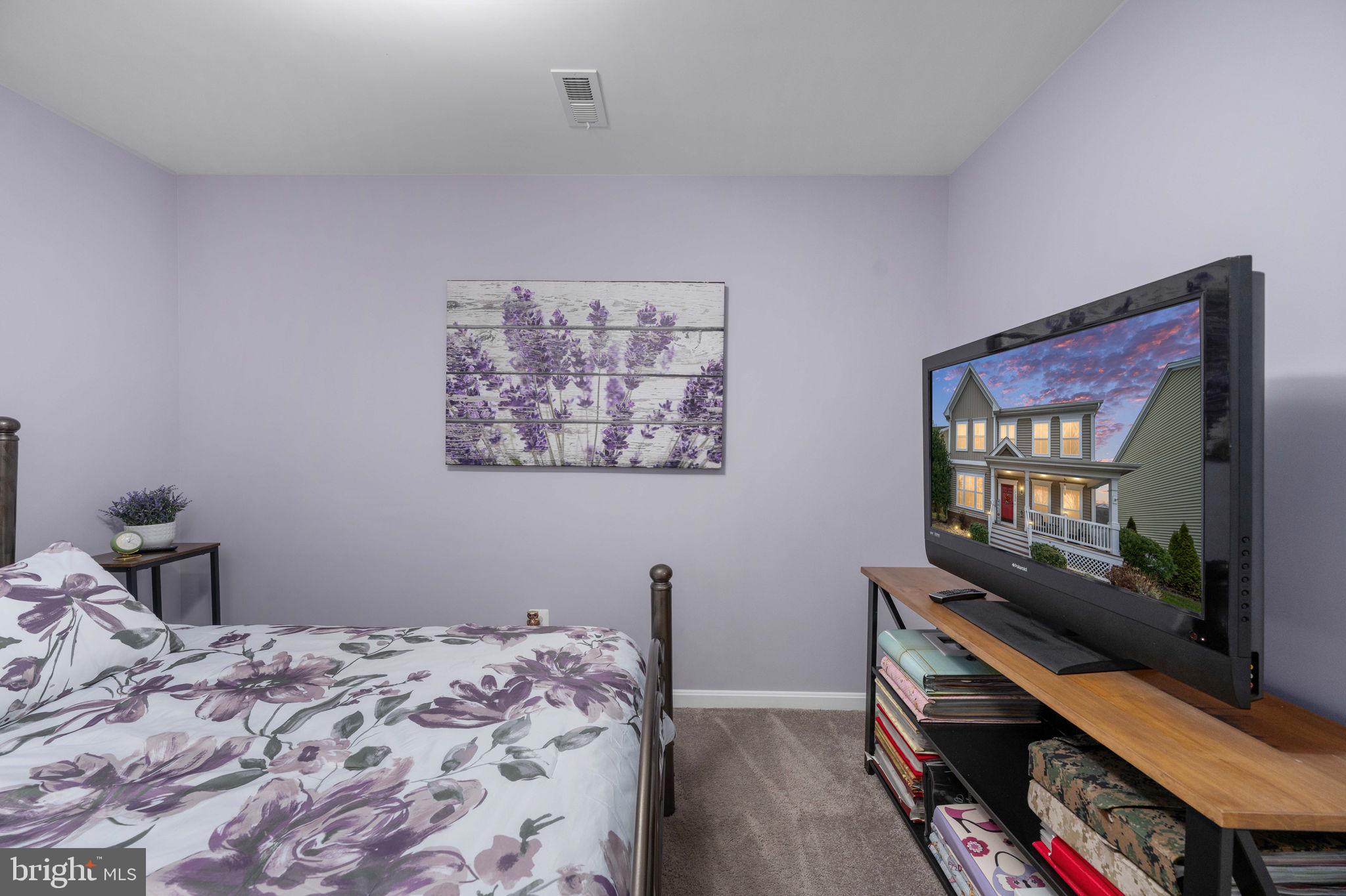 17230 Library Boulevard Ruther Glen, VA 22546 - Photo 49 of 81 a bedroom with a bed and a flat screen tv