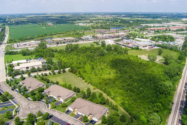 an aerial view of residential houses with outdoor space and river
