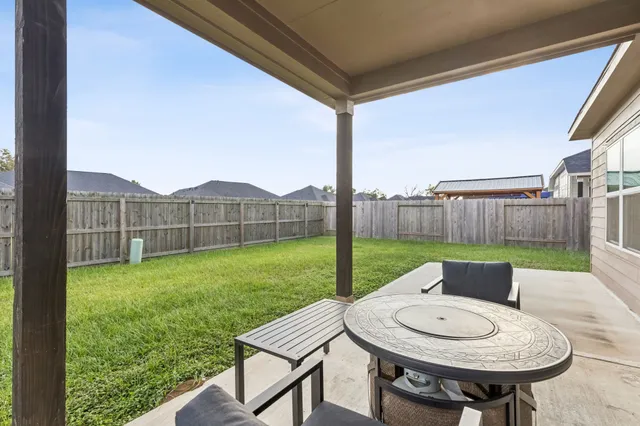 a view of a house with a yard and sitting area