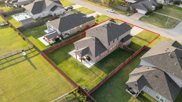 an aerial view of residential houses with outdoor space