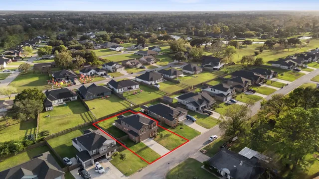 an aerial view of a house with a swimming pool