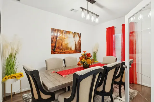 a view of a dining room with furniture and window