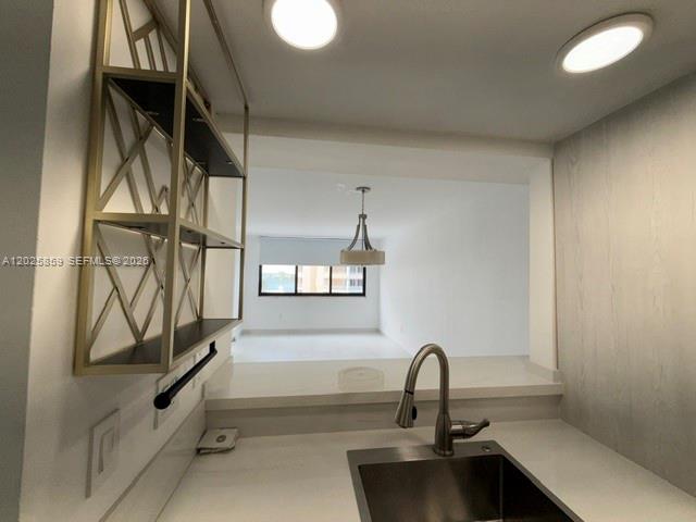 540 Brickell Key Drive, Unit 1024 Miami, FL 33131 - Photo 23 of 28 a kitchen with a sink and cabinets