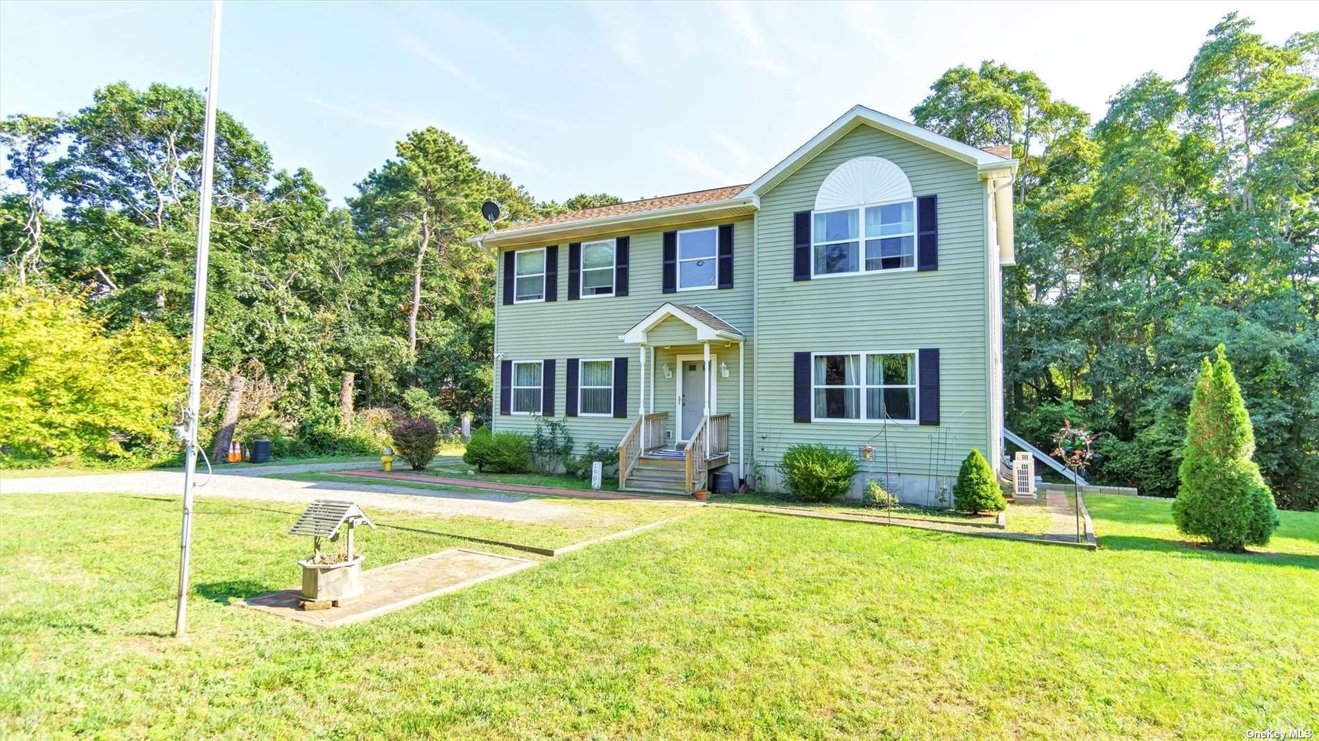 a view of a house with swimming pool and a yard