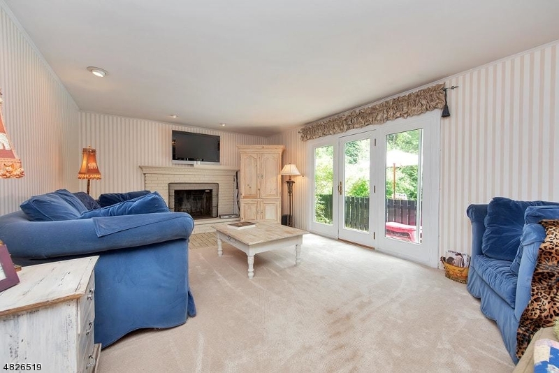 517 High Street Stirling, NJ 07980 - Photo 11 of 22 a living room with furniture a fireplace and a flat screen tv