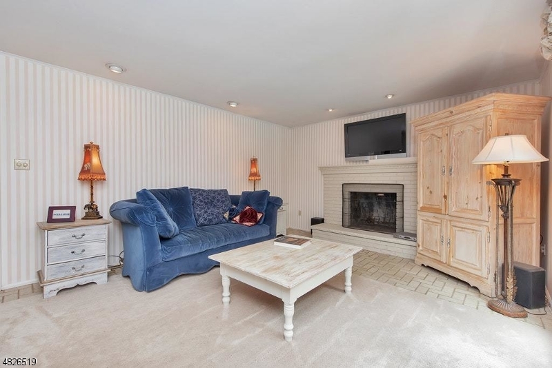 517 High Street Stirling, NJ 07980 - Photo 12 of 22 a living room with furniture a flat screen tv and a fireplace