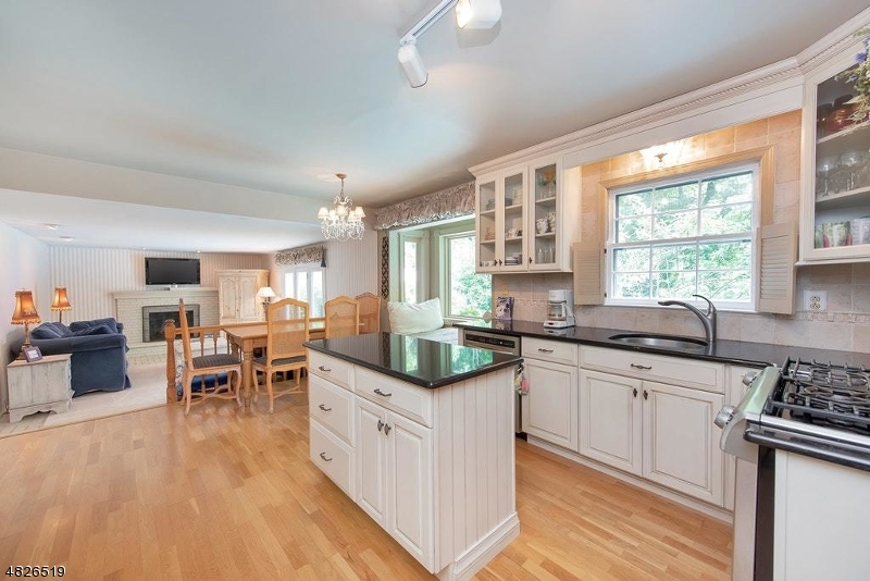 517 High Street Stirling, NJ 07980 - Photo 14 of 22 a kitchen with stainless steel appliances granite countertop a stove top oven a sink dishwasher and white cabinets with wooden floor