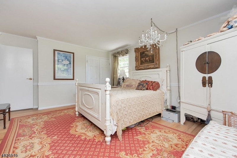 517 High Street Stirling, NJ 07980 - Photo 16 of 22 a bedroom with a bed mirror and a window