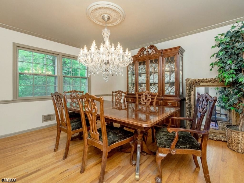 517 High Street Stirling, NJ 07980 - Photo 5 of 22 a view of a dining room with furniture a chandelier and wooden floor