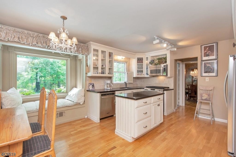 517 High Street Stirling, NJ 07980 - Photo 8 of 22 a kitchen with stainless steel appliances granite countertop a stove and a refrigerator