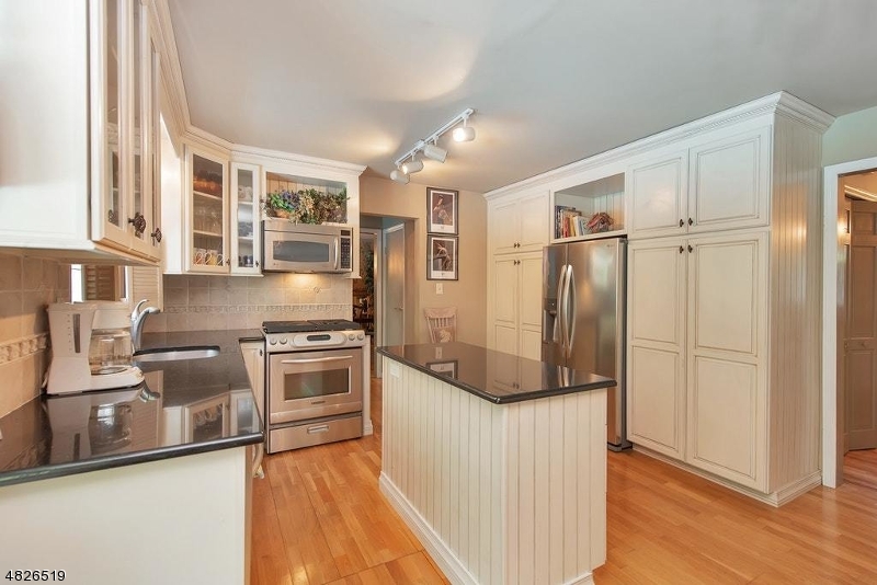 517 High Street Stirling, NJ 07980 - Photo 9 of 22 a kitchen with stainless steel appliances granite countertop a refrigerator and a stove