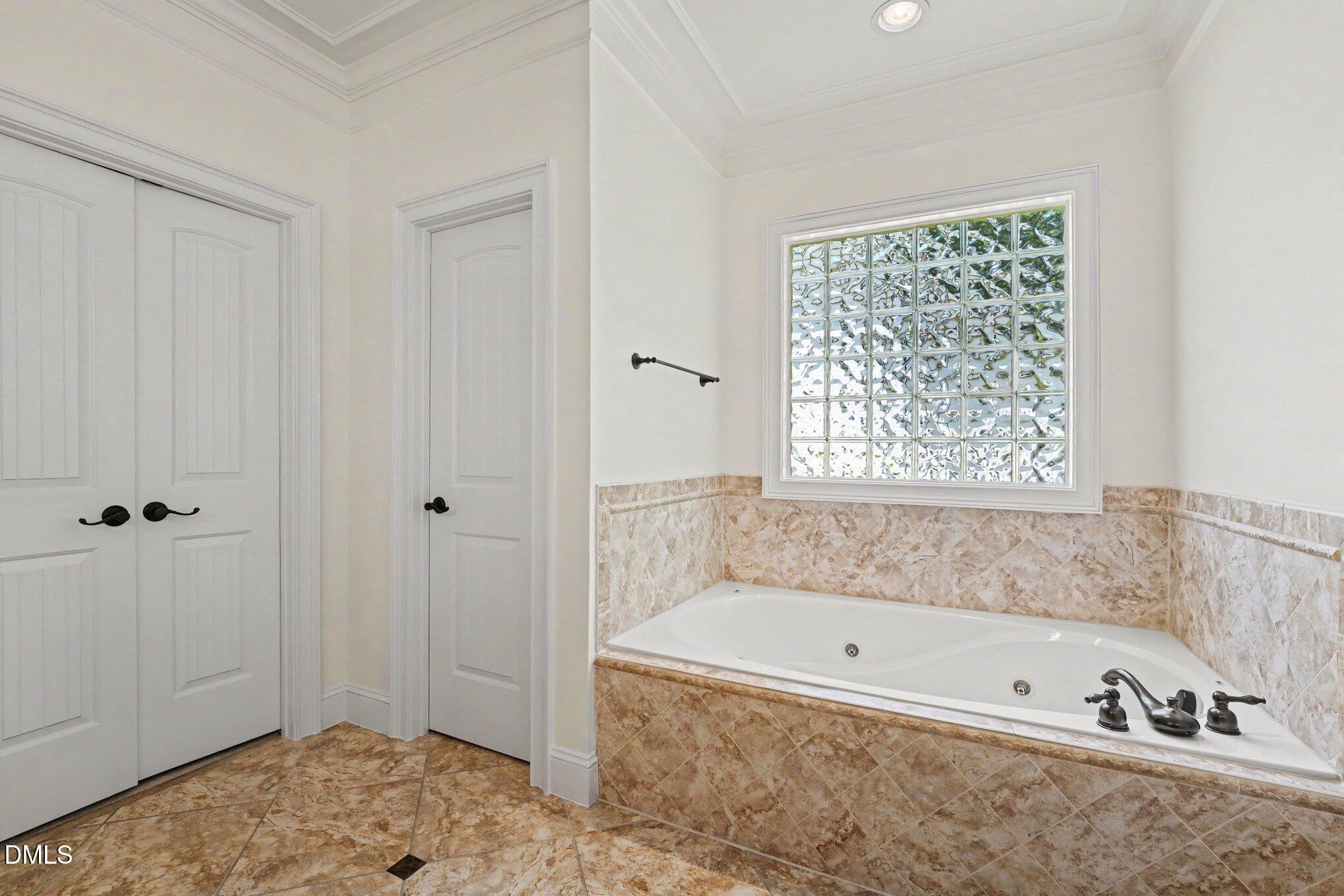 1729 Frenchwood Drive Raleigh, NC 27612 - Photo 15 of 46 a bathroom with a bathtub and a shower