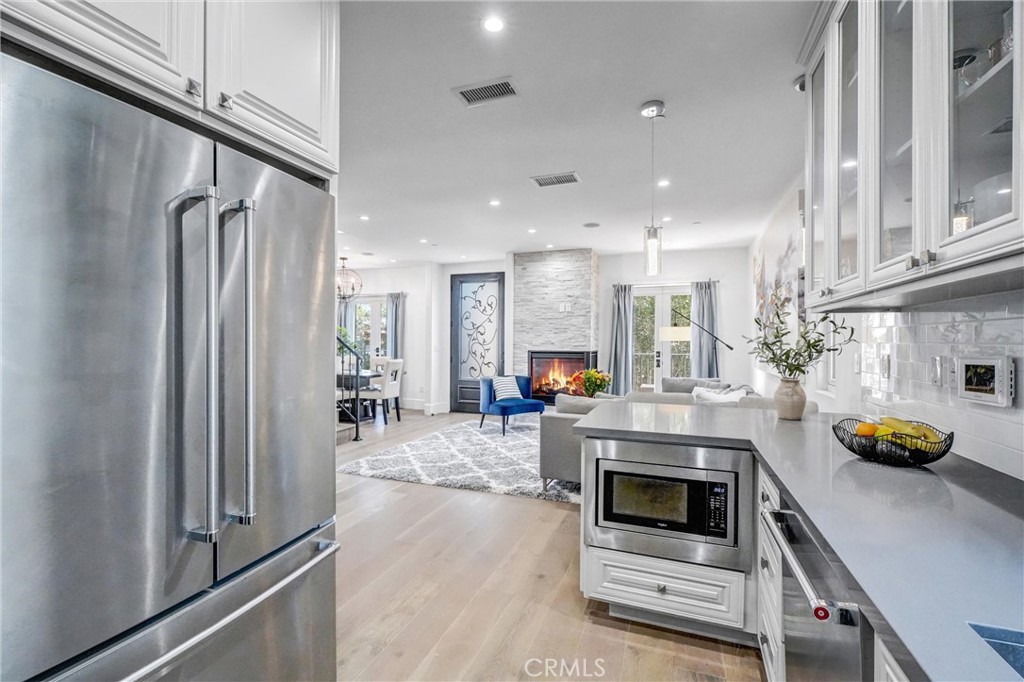 18228 Grevillea Avenue Redondo Beach, CA 90278 - Photo 14 of 39 a kitchen with stainless steel appliances a refrigerator a sink a stove and white cabinets