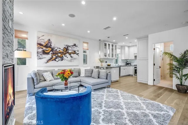 a living room with furniture and kitchen view
