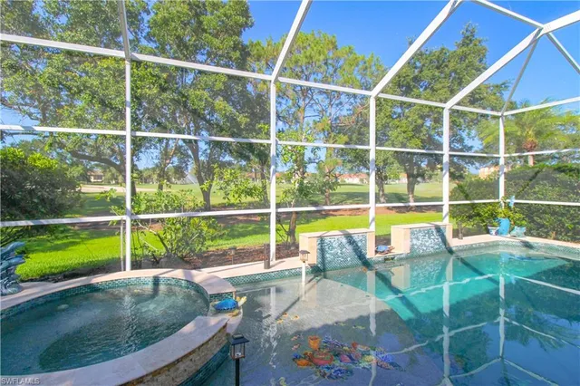a view of a swimming pool with a porch and yard