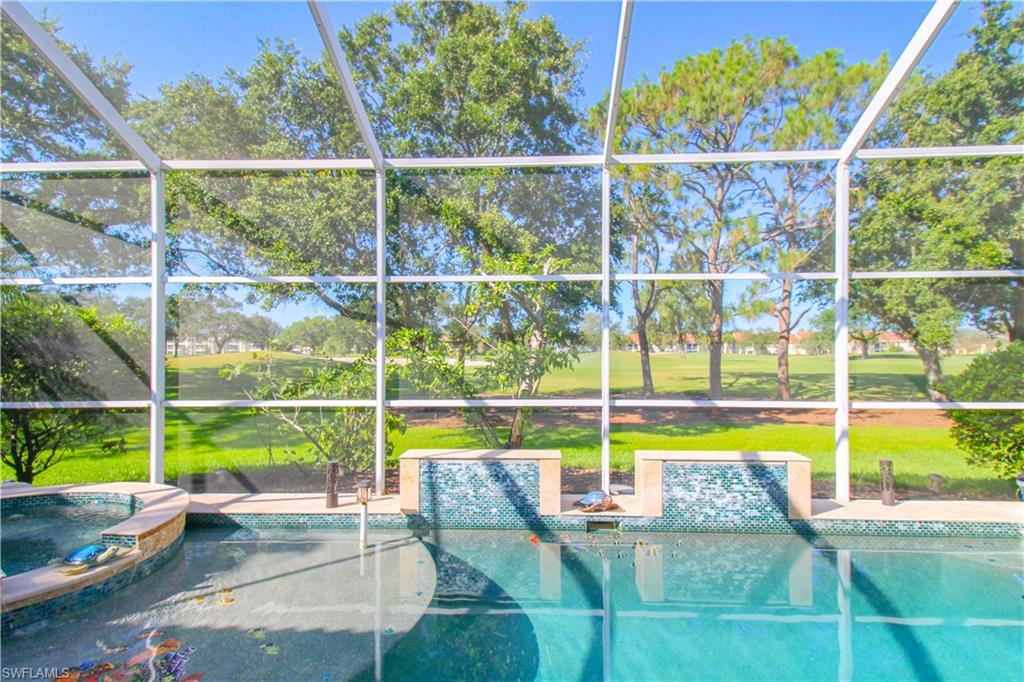 152 Napa Ridge Way Naples, FL 34119 - Photo 12 of 50 a view of a swimming pool with a porch and yard