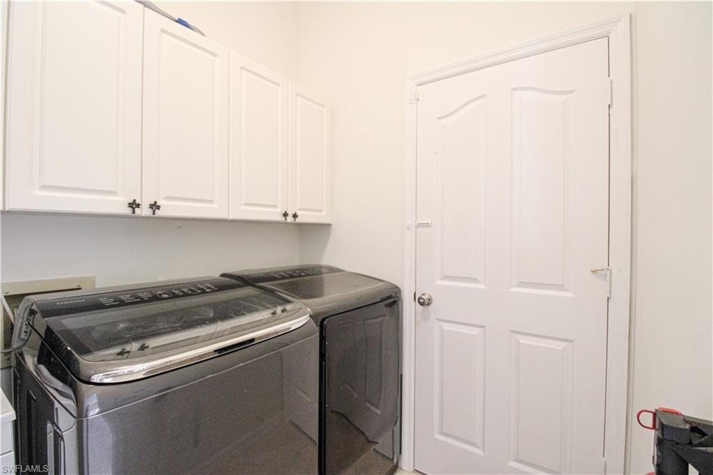 152 Napa Ridge Way Naples, FL 34119 - Photo 15 of 50 a utility room with dryer and washer
