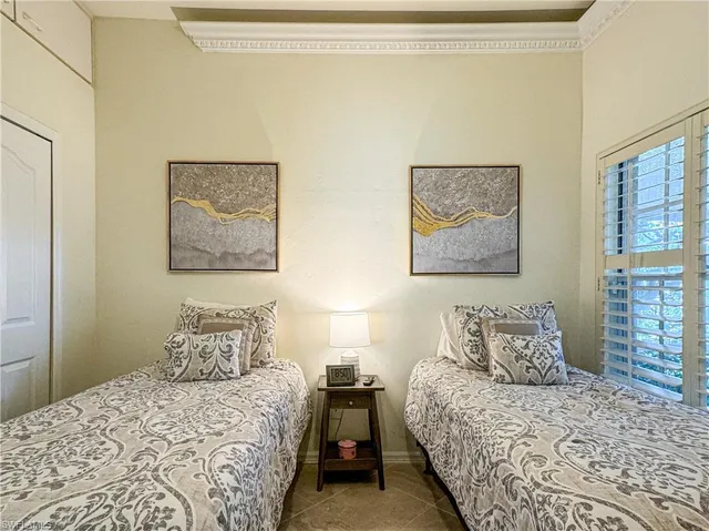 a bedroom with two beds and a flat screen tv