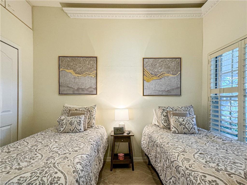 152 Napa Ridge Way Naples, FL 34119 - Photo 19 of 50 a bedroom with bed and wall painting