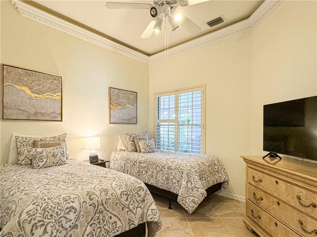 152 Napa Ridge Way Naples, FL 34119 - Photo 20 of 50 a bedroom with two beds and a flat screen tv