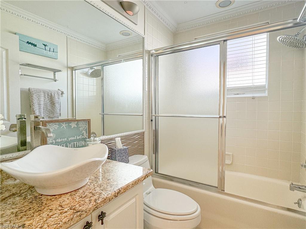152 Napa Ridge Way Naples, FL 34119 - Photo 21 of 50 a bathroom with a granite countertop sink toilet and shower