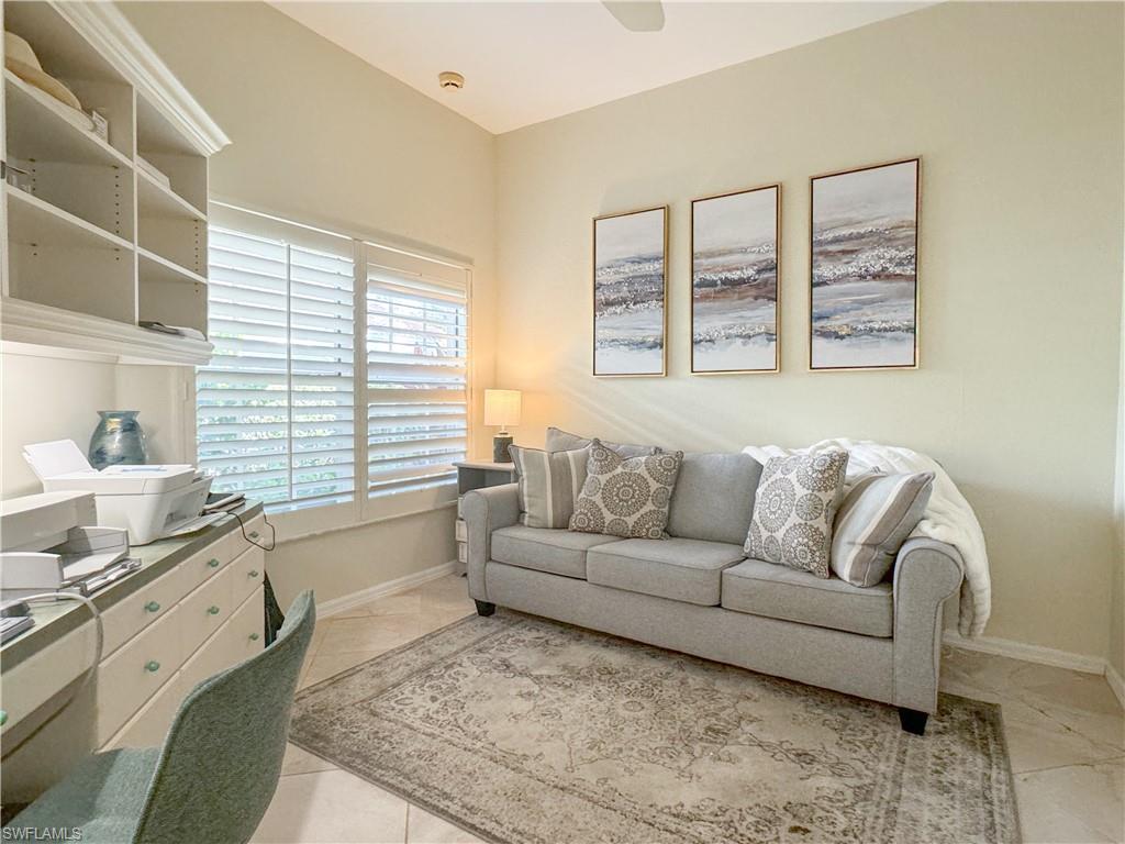 152 Napa Ridge Way Naples, FL 34119 - Photo 23 of 50 a living room with furniture and a large window