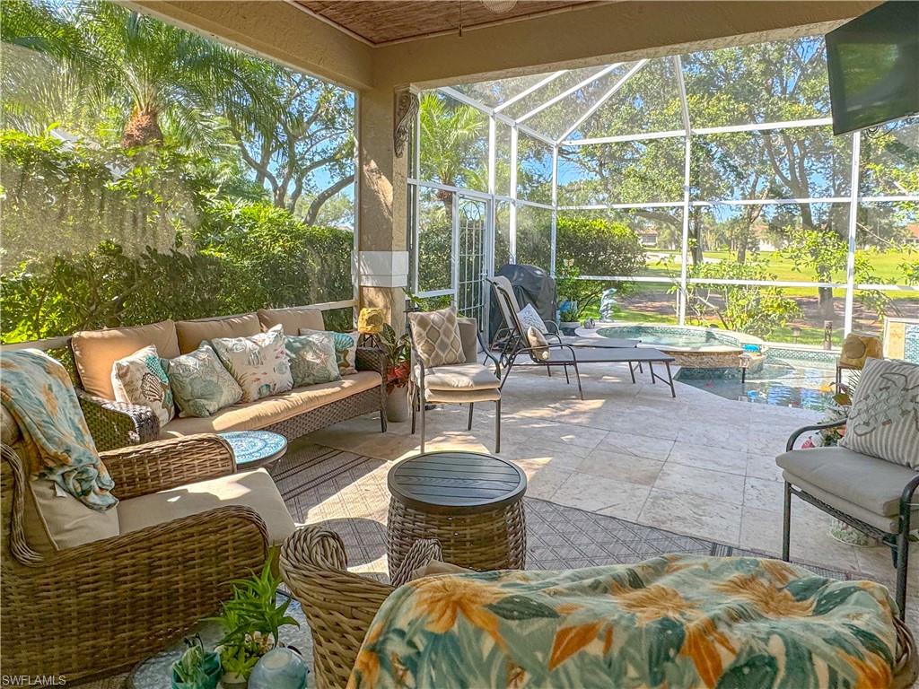 152 Napa Ridge Way Naples, FL 34119 - Photo 26 of 50 a view of a patio with couches chairs and a potted plant