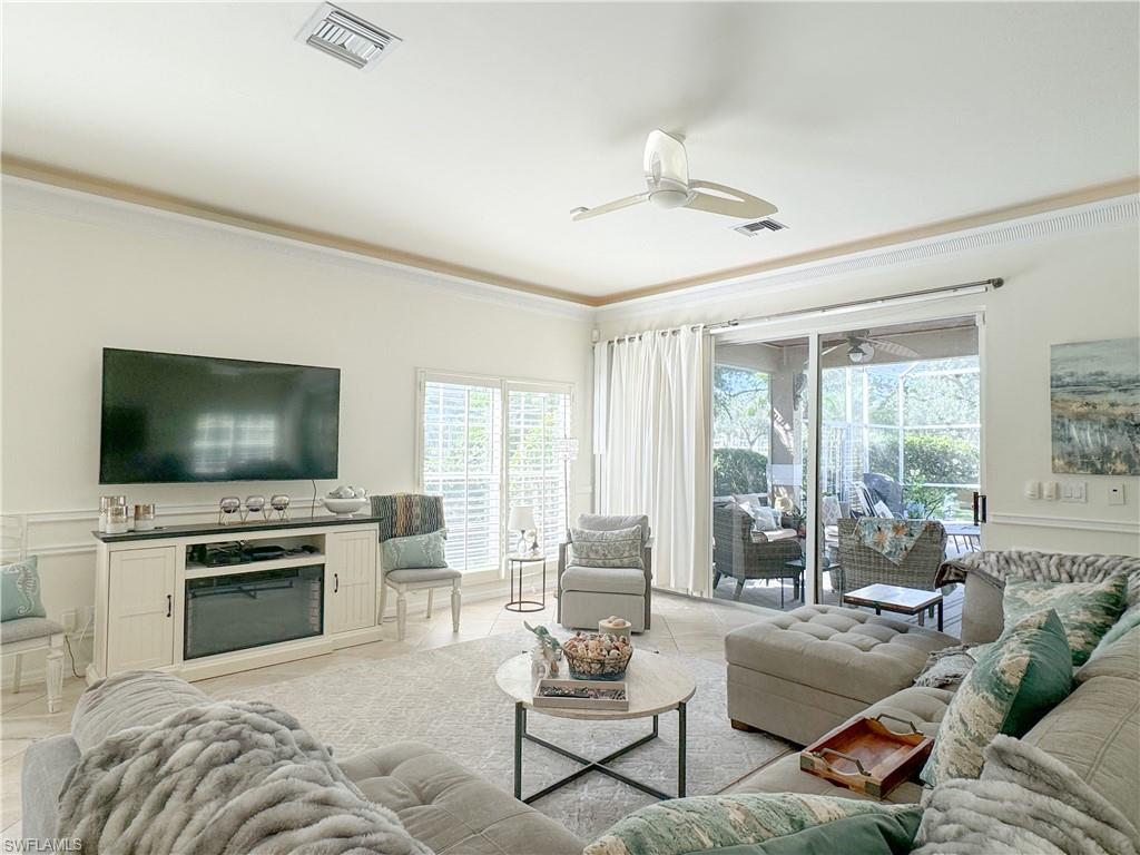 152 Napa Ridge Way Naples, FL 34119 - Photo 27 of 50 a living room with furniture and a flat screen tv
