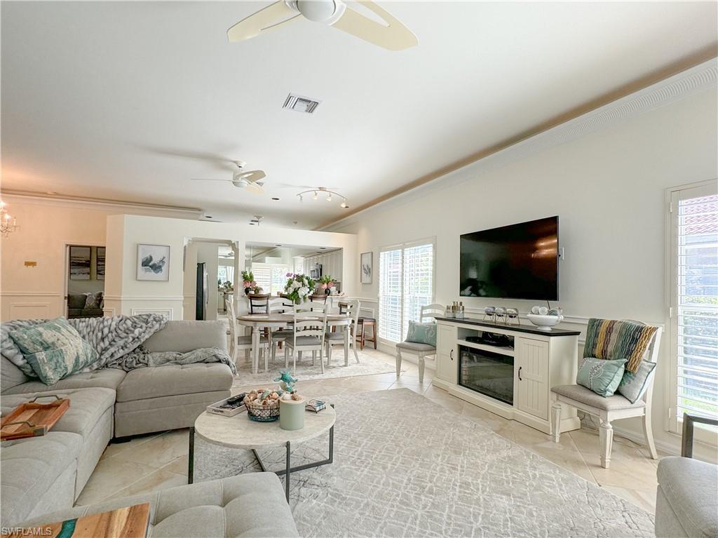 152 Napa Ridge Way Naples, FL 34119 - Photo 29 of 50 a living room with furniture and a flat screen tv