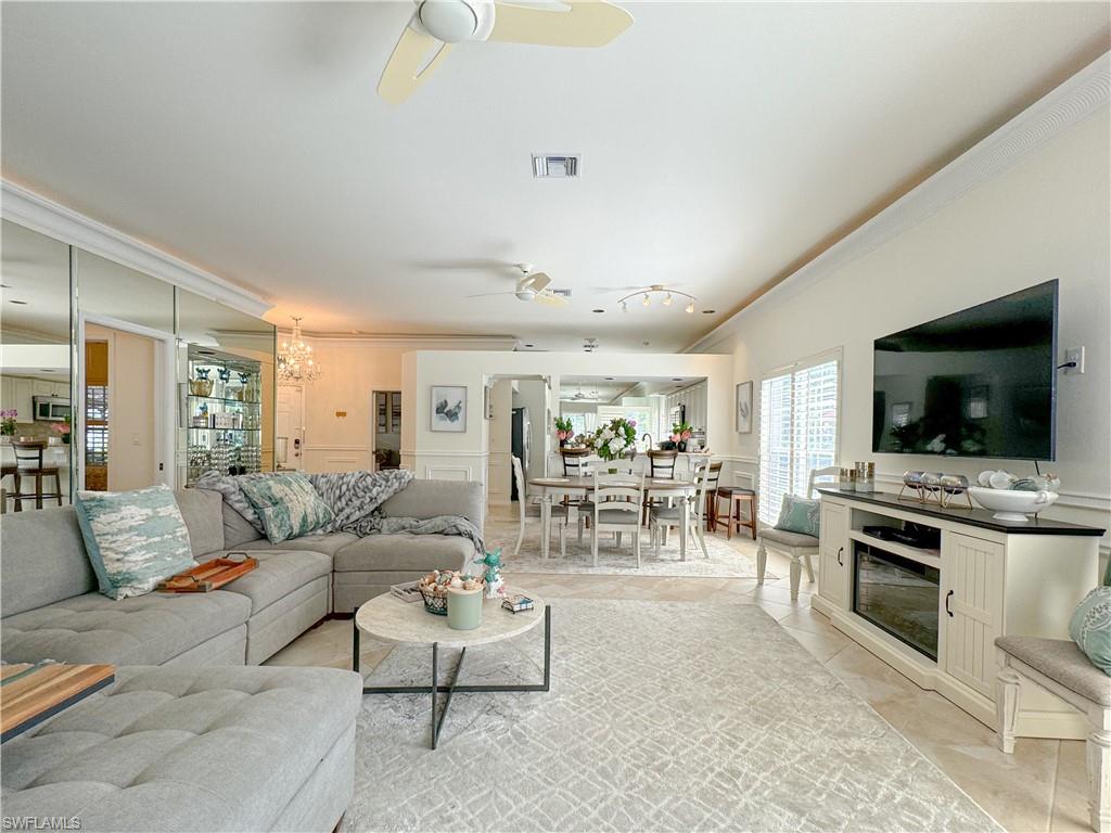 152 Napa Ridge Way Naples, FL 34119 - Photo 30 of 50 a living room with furniture and a flat screen tv