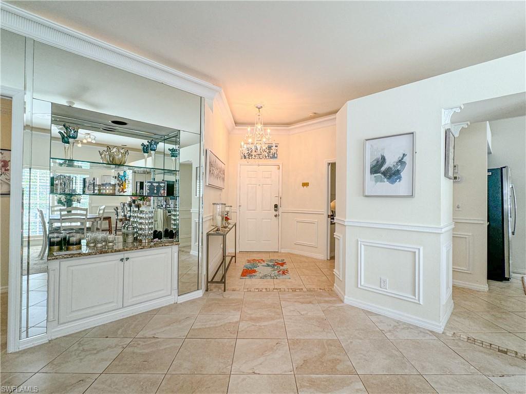 152 Napa Ridge Way Naples, FL 34119 - Photo 34 of 50 a bathroom with a bathtub sink and mirror