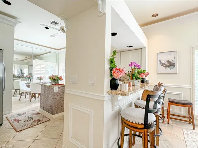 a kitchen with stainless steel appliances kitchen island granite countertop a table and chairs in it