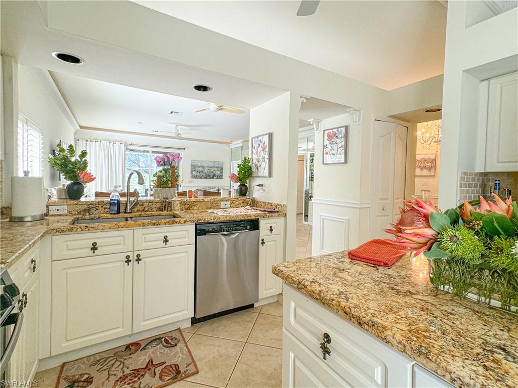 152 Napa Ridge Way Naples, FL 34119 - Photo 41 of 50 a kitchen with granite countertop cabinets and chair