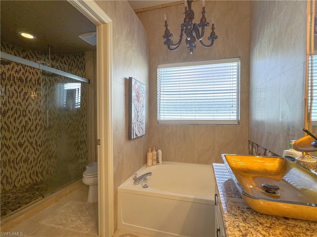 152 Napa Ridge Way Naples, FL 34119 - Photo 50 of 50 a bathroom with a sink a toilet and shower