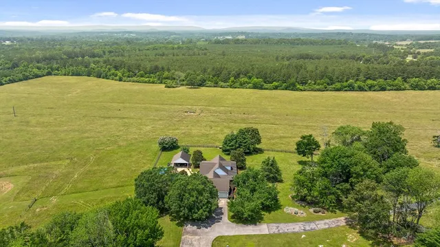 a living room with furniture a flat screen tv and a large window