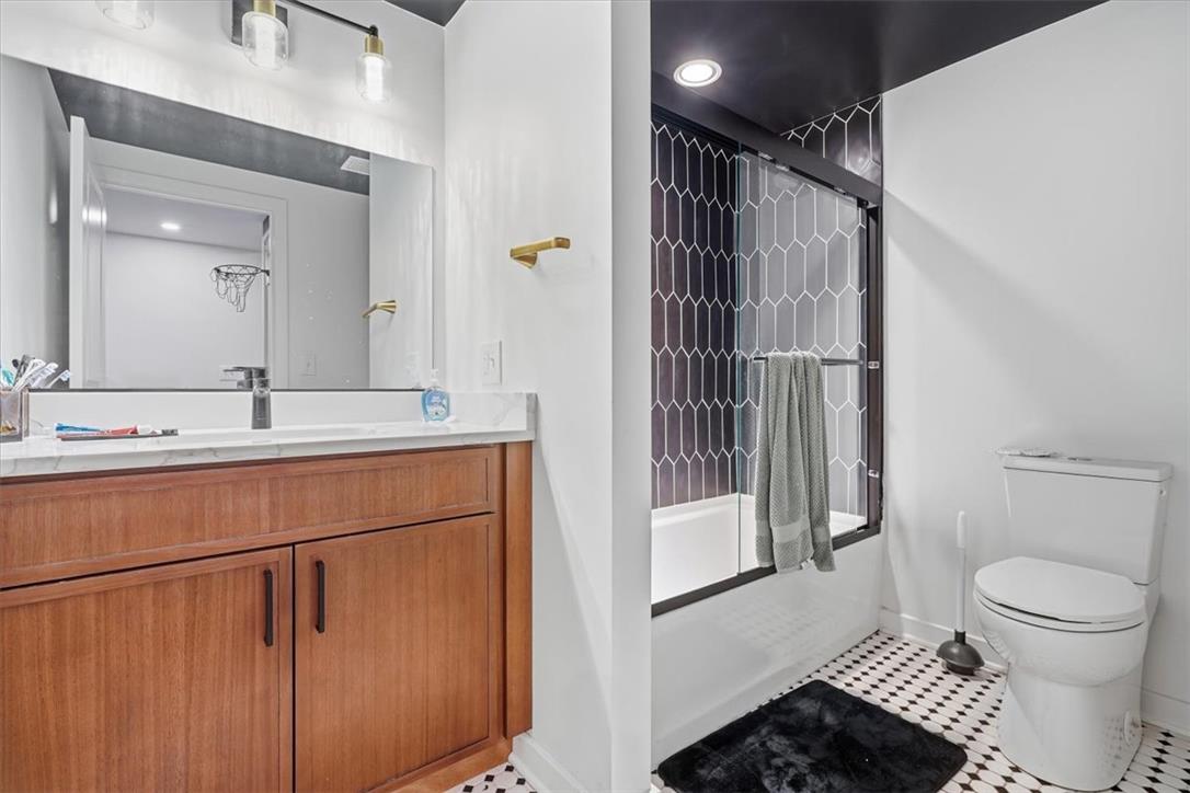 2930 Oakland Road Bethlehem, PA 18017 - Photo 33 of 55 A modern bathroom showcases a stylish tile shower surround alongside a wood vanity.