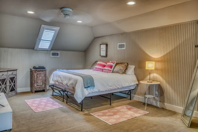 a bedroom with a bed a table and chair